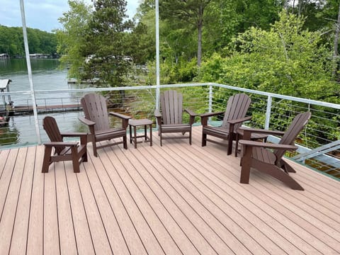 4 Adirondack chairs and tables on the top deck with sun sail