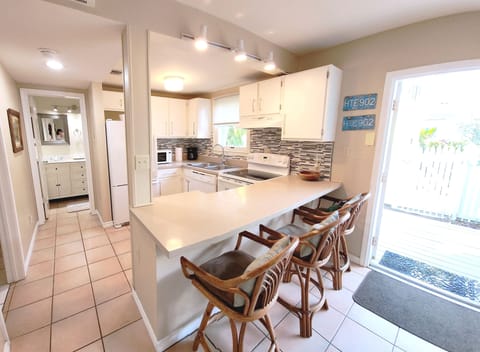 Countertop seating, sunny and bright full size kitchen by outdoor deck