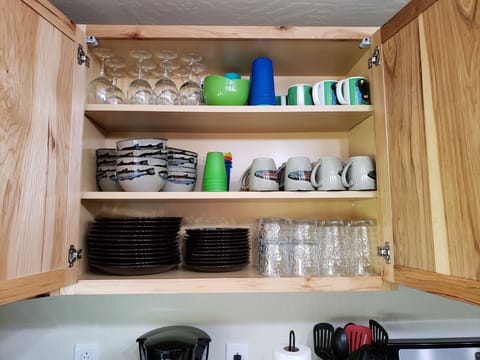 Kitchen plates, glasses, mugs and wine glasses.