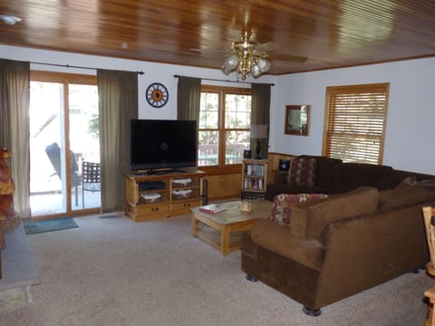 Family room with patio doors to deck and gas grill.