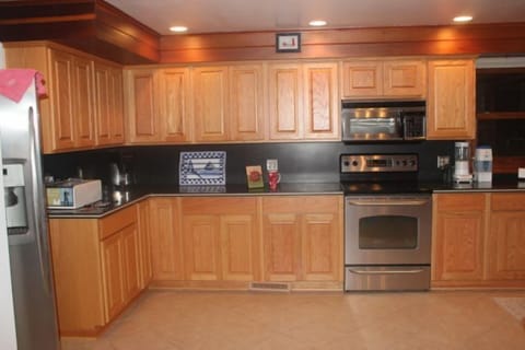 main floor full kitchen, stainless steel dishwasher, oven, microwave, fridge 
