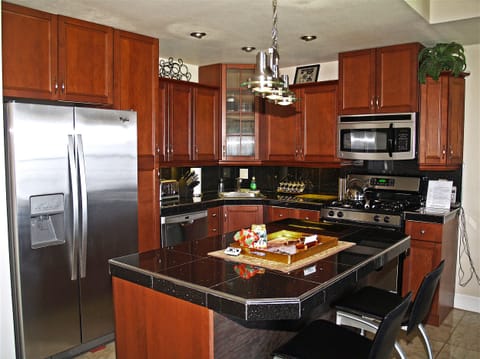 Exquisite Cherry Kitchen with Black Granite counters