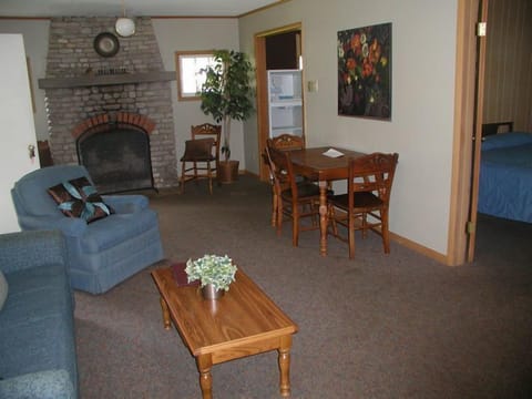 The living room has a working fireplace and a large bay window.
