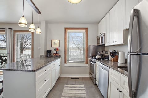 There are cabinets and refrigerators on each end of the kitchen,