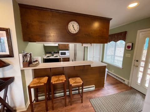 Kitchen with plenty of amenities, like pots, pans, & utensils.