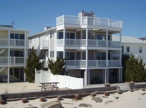 View of home from the beach. Elevated mid level is the living unit.