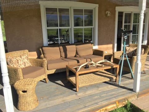 Outdoor conversational seating area under the portal with views of the pond