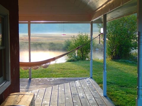 Porch and hammock looking onto the pond in early morning 