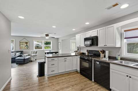 Updated kitchen with peninsula and barstools