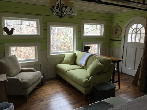 Quaint and cozy living space with bar and adjustable stools