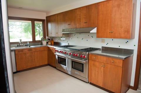 kitchen with 60" Wolf double oven stove - 6 burners and double griddle