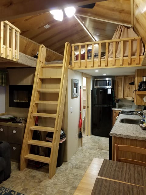 Stairs to sleeping loft. 2 sleeping areas. One on each end of the cabin.