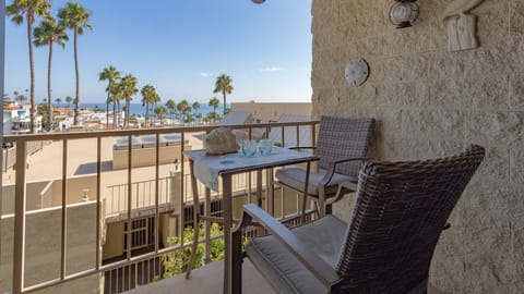 Ocean view from balcony patio with cocktail table and chairs