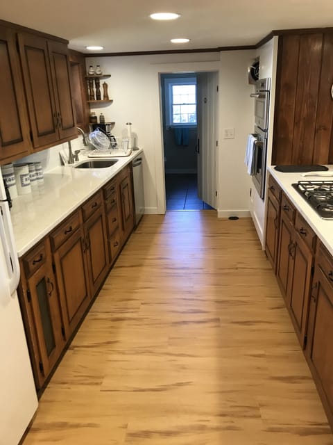 Kitchen with new counters, backsplash, appliances, and remodeled bathroom
