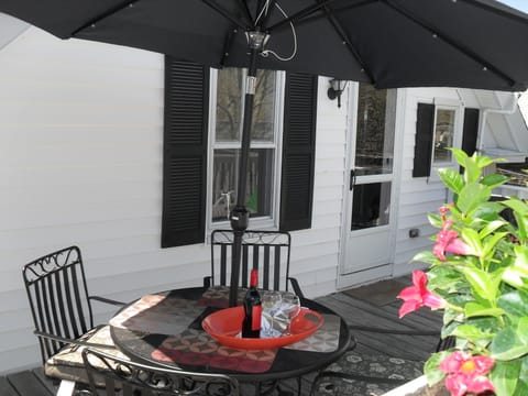 Outdoor dining with an umbrella that provides shade on those hot Ptown days.