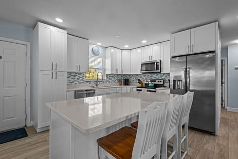 Kitchen with seating for 3 at the island.