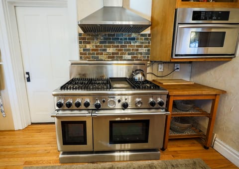 Large kitchen with commercial oven/range and ample counter space
