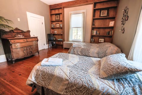 Main floor office, now a bedroom with two full beds and one twin