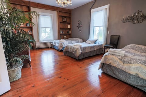 Main floor office, now a bedroom with two full beds and one twin