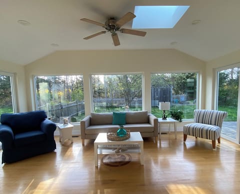Sunroom overlooking private, fenced in yard.