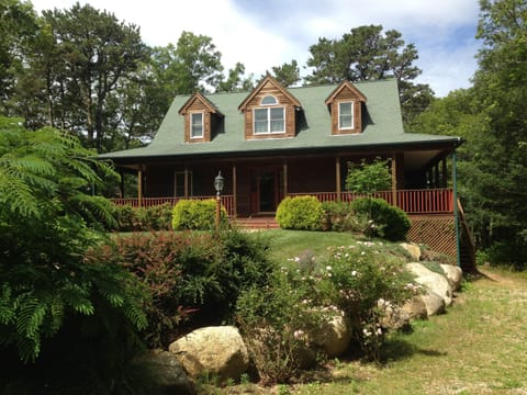 Sitting over an acre of private yard with green lawn, decorative pond and garden