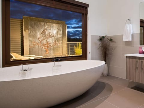 Luxurious stone bath and water feature at dusk