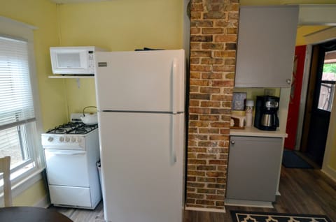 Kitchen with full-size refrigerator, microwave, and gas stove.