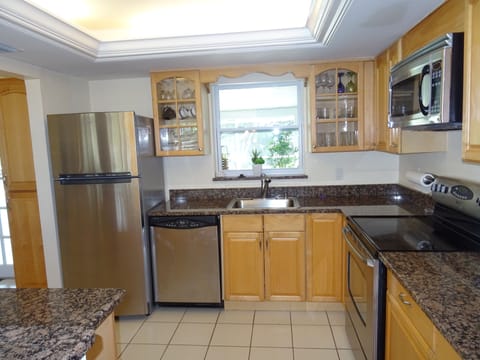 kitchen with serving window and view to pool terrace
