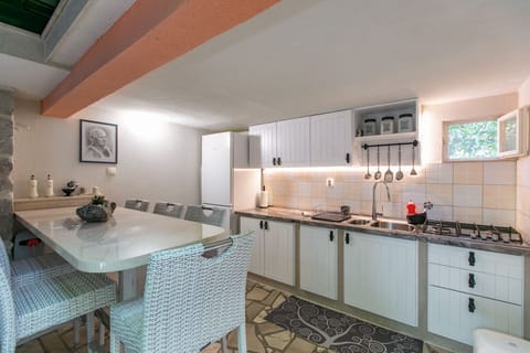 Summer kitchen with refrigerator, stove and all cooking utensils