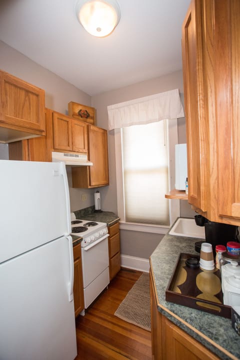 Kitchen with stove, fridge, microwave, Keurig coffee bar, snacks, dishes, etc. 