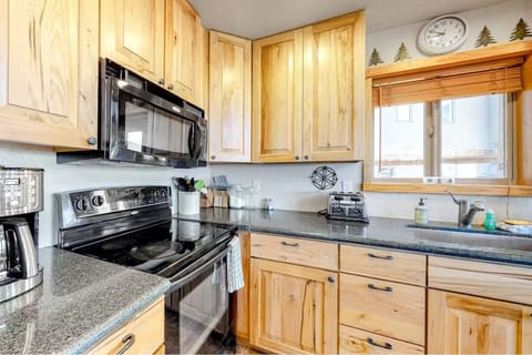 Well appointed kitchen with island and bar stools.