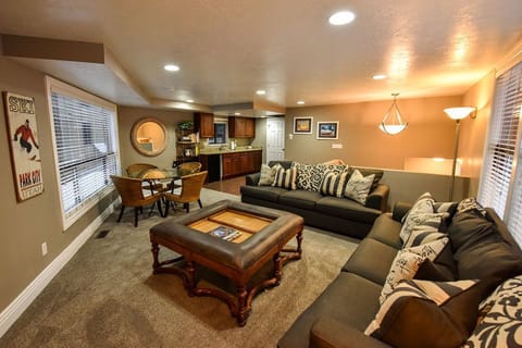 Living room with wood burning fireplace, game table and kitchenette 