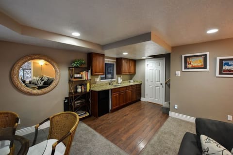Kitchenette with sink and refrigerator 
White door leads to 1/2 bath
