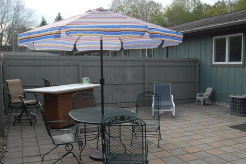 Patio includes a bar, table and chairs, chaise lounge