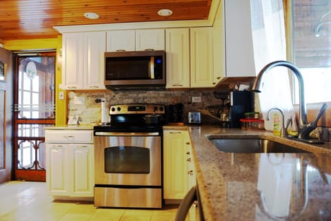 Kitchen sink, granite counter top, and stove/microwave