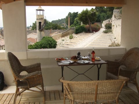 Covered dining area on the terrace looking onto the garden of the castle