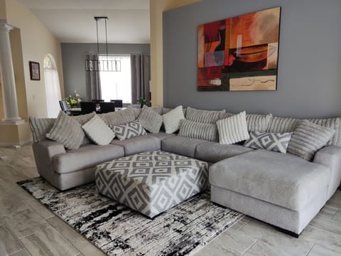 Living room with very comfortable couch with Smart TV.