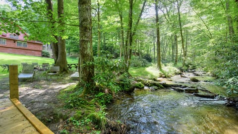 creek behind house with sitting area and fire pit