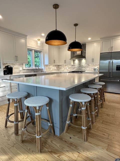 large kitchen island surrounded by 6 Serena and Lily stools