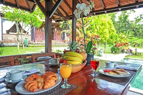 Serving breakfast overlooking the pool and garden