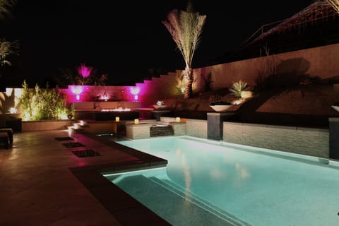 Pool at night with lounging bench