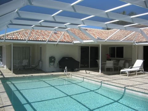 Enjoy the large south facing pool and 1700 Sq. Ft. Screened Lanai