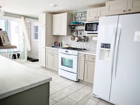 Fully equipped kitchen with Kenmore Elite appliances and solid surface tops.