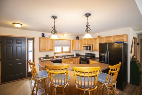 Full kitchen with additional seating.
Large refrigerator.