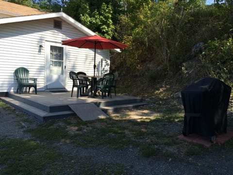 Umbrella with table and chairs on side deck.