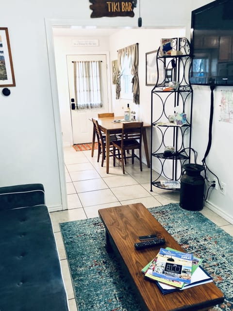 Living room looking at the dining table and front door.