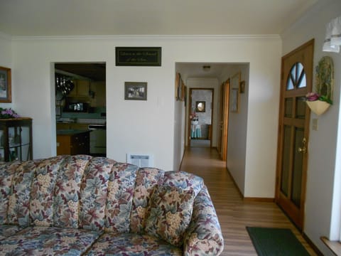 Living room looking into hallway and large front bedroom.