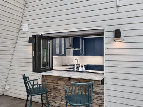 Pass-through kitchen window with counter seating on the upper deck.