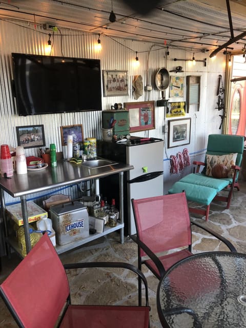 man cave tv, fridge and sink