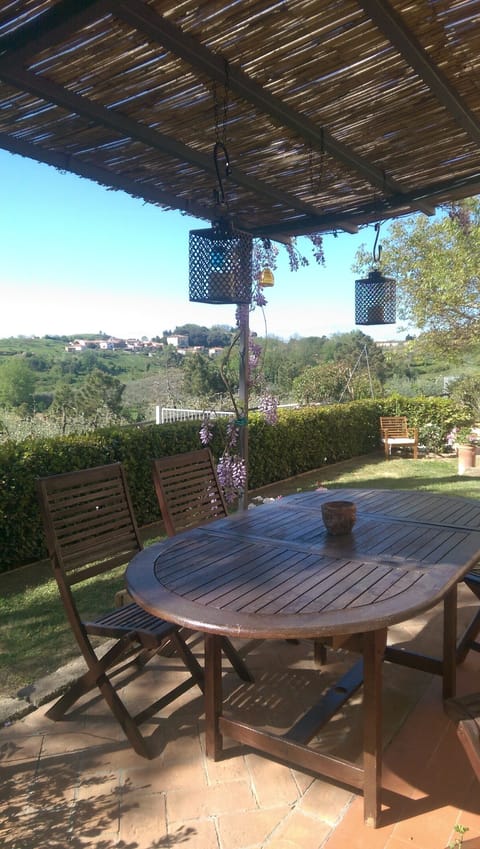 covered patio and dining table in private garden